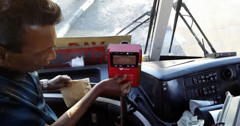 Paying the fare on a Fijan bus